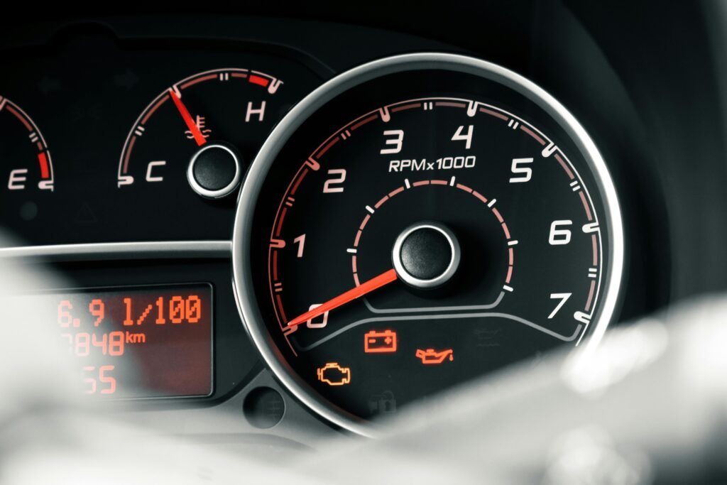 Detailed view of a car dashboard featuring tachometer, odometer, and various indicators.
