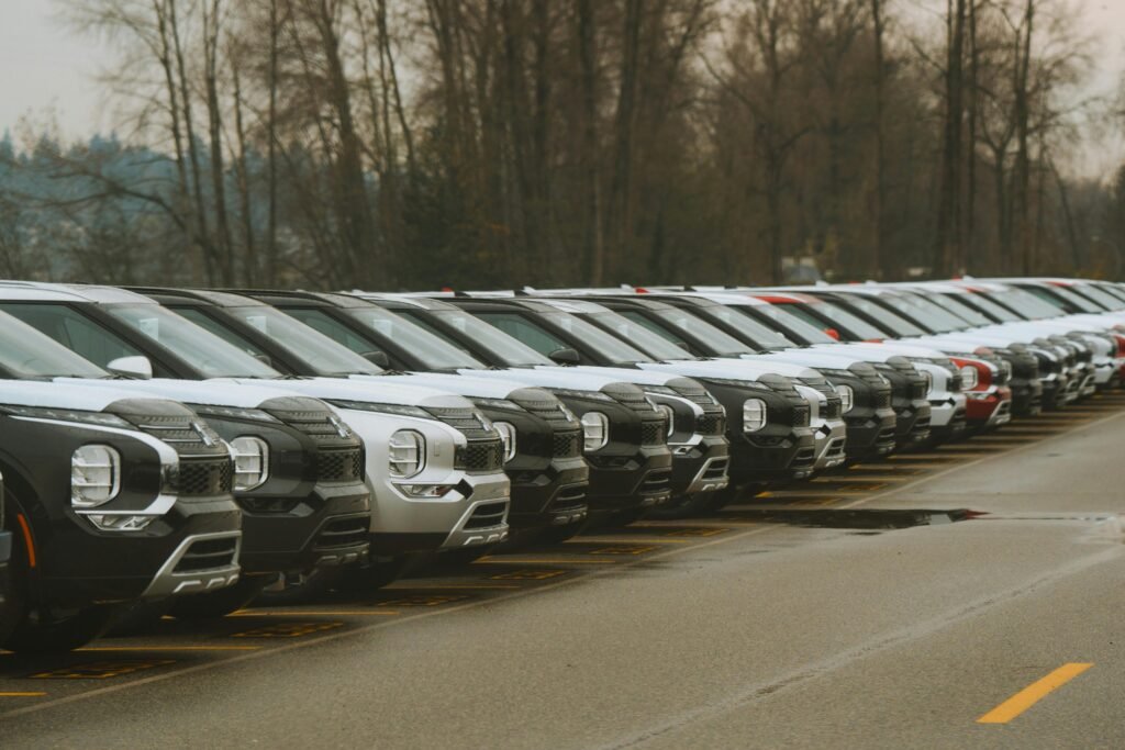 A row of new cars parked outdoors, showcasing modern vehicle design.