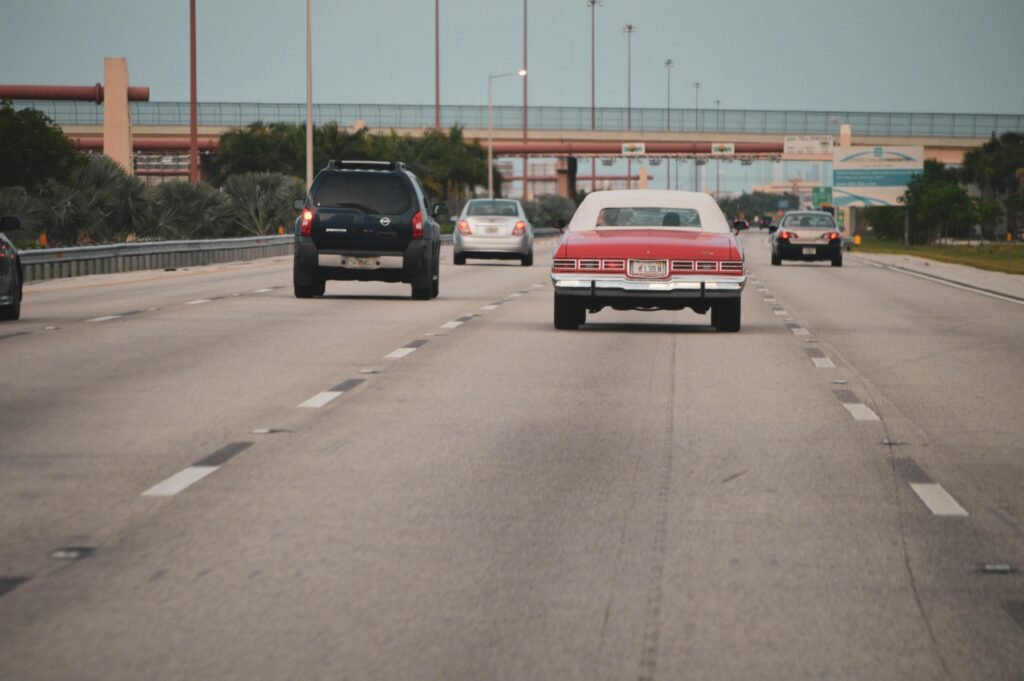 Highway traffic scene with classic car in Miami, Florida, showcasing urban travel atmosphere.